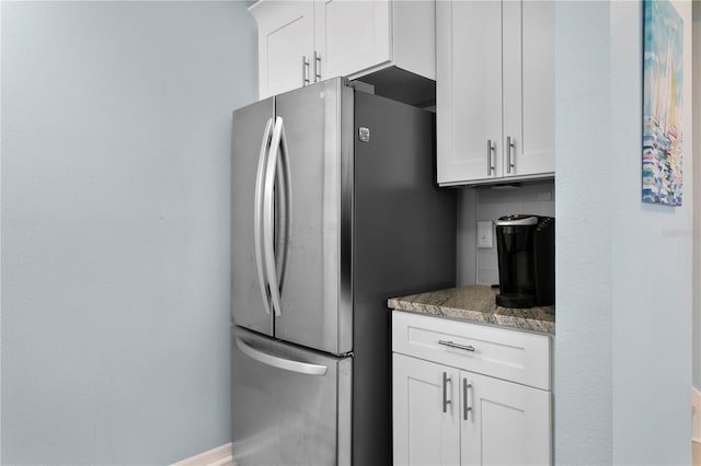 501 Knights Run Ave Unit 5103, Tampa, FL 33602 - kitchen with freestanding refrigerator, white cabinets, and light stone countertops