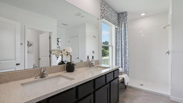 4401 Sand Dollar Way, Zephyrhills, FL 33541 - full bathroom with tiled shower, double vanity, and tile patterned flooring