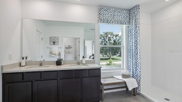 4401 Sand Dollar Way, Zephyrhills, FL 33541 - bathroom with double vanity, a tile shower, and tile patterned floors
