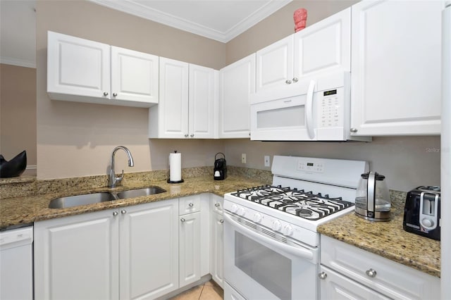 2705 Via Murano Unit 127, Clearwater, FL 33764 - kitchen with white appliances, a sink, crown molding, white cabinets, and light stone countertops