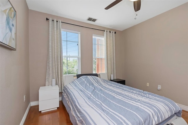 2705 Via Murano Unit 127, Clearwater, FL 33764 - bedroom featuring wood finished floors, baseboards, and ceiling fan