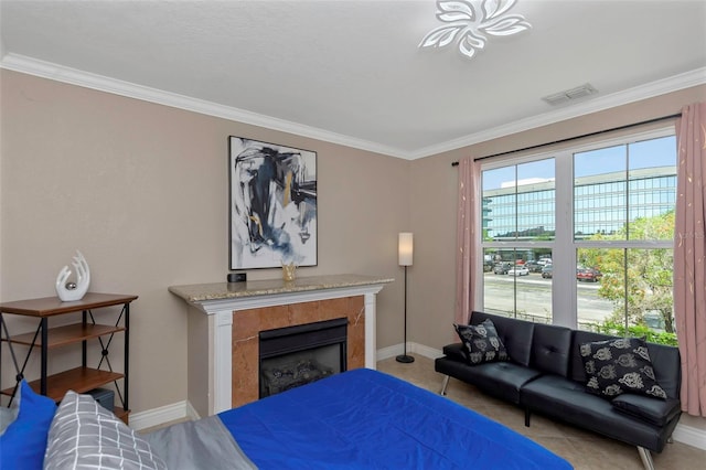 2705 Via Murano Unit 127, Clearwater, FL 33764 - bedroom with ornamental molding, baseboards, a premium fireplace, and light tile patterned floors