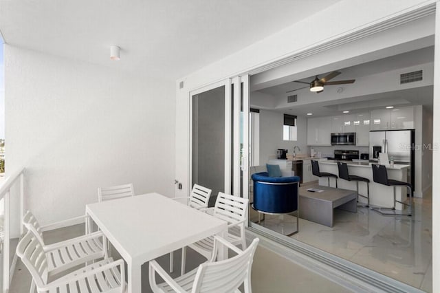 11500 Gulf Blvd Unit 513, Treasure Island, FL 33706 - dining room featuring light marble finish floors and ceiling fan