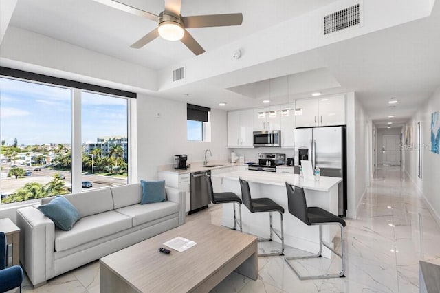 11500 Gulf Blvd Unit 513, Treasure Island, FL 33706 - living room with light marble finish flooring, recessed lighting, a ceiling fan, and baseboards