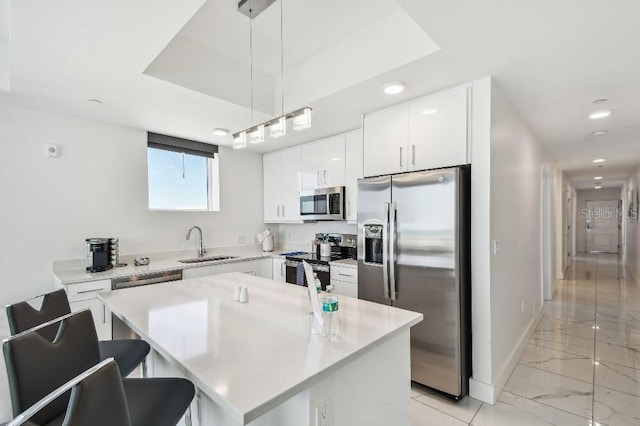 11500 Gulf Blvd Unit 513, Treasure Island, FL 33706 - kitchen with stainless steel appliances, a sink, light marble finish flooring, recessed lighting, and hanging light fixtures