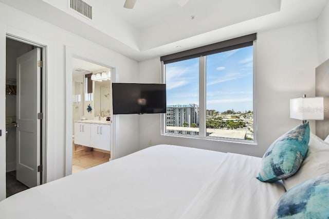 11500 Gulf Blvd Unit 513, Treasure Island, FL 33706 - bedroom with ensuite bath, a sink, a ceiling fan, and a tray ceiling