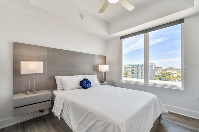 11500 Gulf Blvd Unit 513, Treasure Island, FL 33706 - bedroom with dark wood-style flooring, a ceiling fan, baseboards, and a city view