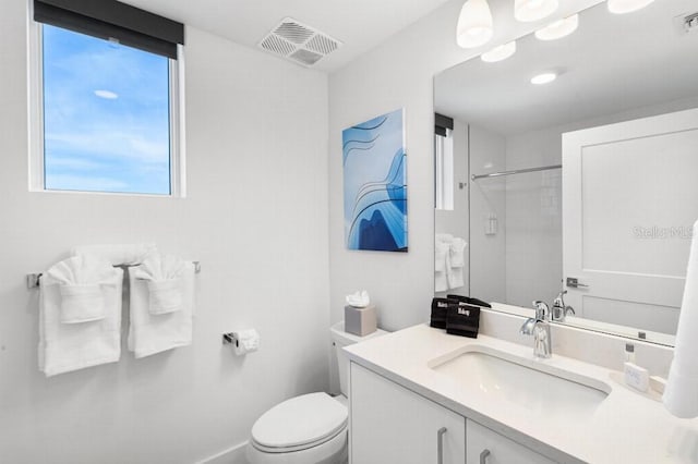 11500 Gulf Blvd Unit 513, Treasure Island, FL 33706 - bathroom featuring healthy amount of natural light, toilet, vanity, and a shower