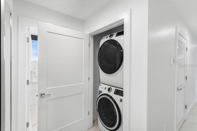 11500 Gulf Blvd Unit 513, Treasure Island, FL 33706 - washroom with stacked washing machine and dryer and baseboards