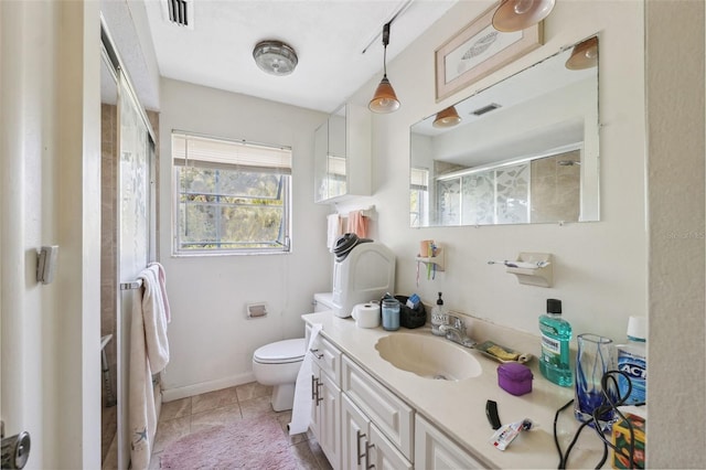 108 Shore Dr, Tarpon Springs, FL 34689 - full bathroom featuring a shower with shower door, vanity, toilet, tile patterned floors, and baseboards