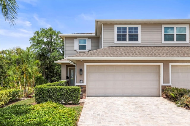 5332 Riverwalk Preserve Dr, New Port Richey, FL 34653 - view of front of house featuring stone siding, a shingled roof, and driveway