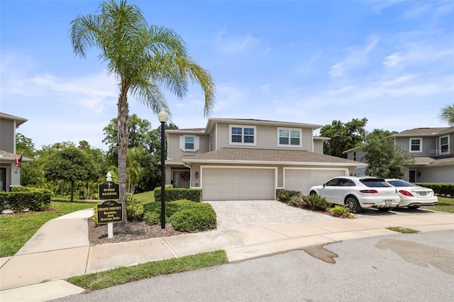 5332 Riverwalk Preserve Dr, New Port Richey, FL 34653 - traditional-style home featuring driveway, an attached garage, and roof with shingles