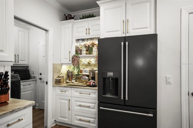 5332 Riverwalk Preserve Dr, New Port Richey, FL 34653 - kitchen with black fridge with ice dispenser, crown molding, white cabinets, dark wood-style floors, and light stone countertops
