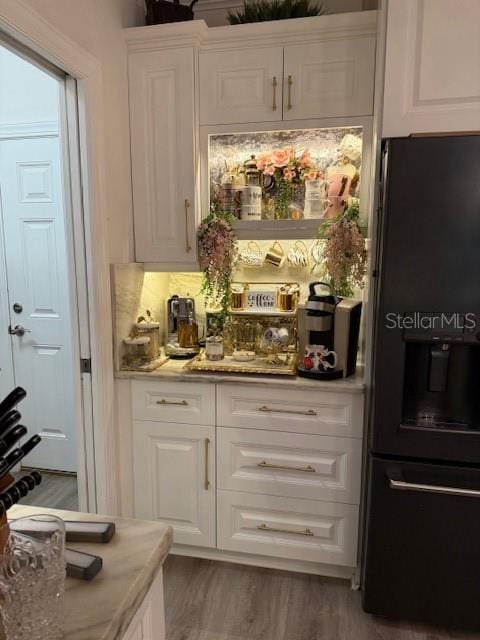 5332 Riverwalk Preserve Dr, New Port Richey, FL 34653 - bar area with black refrigerator with ice dispenser and wood finished floors