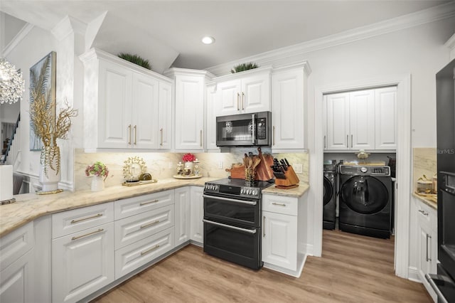 5332 Riverwalk Preserve Dr, New Port Richey, FL 34653 - kitchen featuring stainless steel microwave, range with two ovens, washer and clothes dryer, white cabinetry, and crown molding