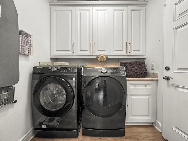 5332 Riverwalk Preserve Dr, New Port Richey, FL 34653 - washroom with cabinet space, separate washer and dryer, wood finished floors, and baseboards