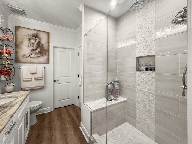 5332 Riverwalk Preserve Dr, New Port Richey, FL 34653 - full bathroom featuring a tile shower, wood finished floors, vanity, crown molding, and toilet