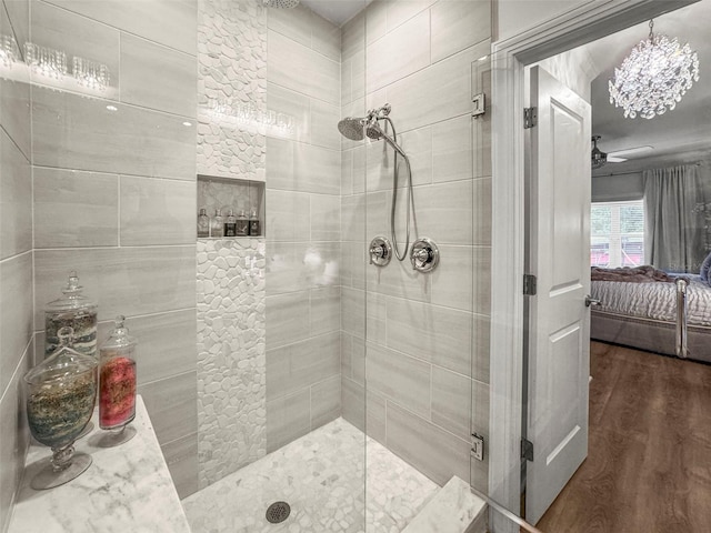 5332 Riverwalk Preserve Dr, New Port Richey, FL 34653 - full bath with ensuite bathroom, a shower stall, wood finished floors, a ceiling fan, and a chandelier