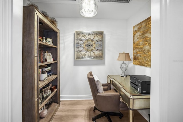 5332 Riverwalk Preserve Dr, New Port Richey, FL 34653 - office featuring wood finished floors, a chandelier, and baseboards