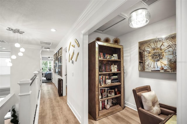 5332 Riverwalk Preserve Dr, New Port Richey, FL 34653 - hall with an upstairs landing, light wood-type flooring, crown molding, and baseboards