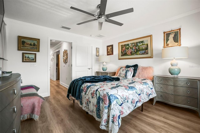 5332 Riverwalk Preserve Dr, New Port Richey, FL 34653 - bedroom with crown molding, wood finished floors, a ceiling fan, and baseboards