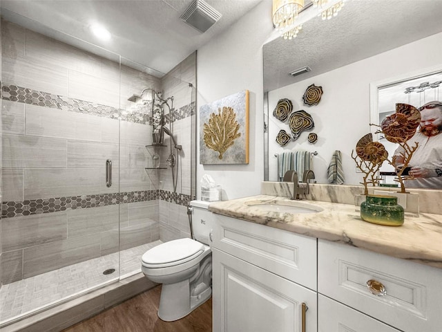 5332 Riverwalk Preserve Dr, New Port Richey, FL 34653 - bathroom with vanity, wood finished floors, toilet, and a stall shower