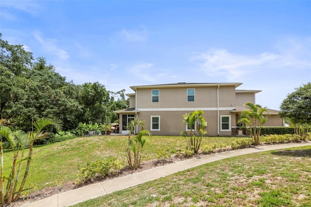 5332 Riverwalk Preserve Dr, New Port Richey, FL 34653 - view of property exterior featuring stucco siding and a lawn