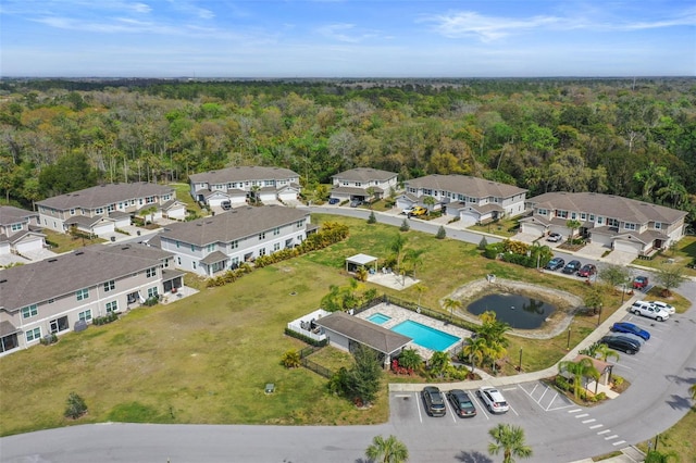 5332 Riverwalk Preserve Dr, New Port Richey, FL 34653 - view of property location with a forest, a pool area, and nearby suburban area