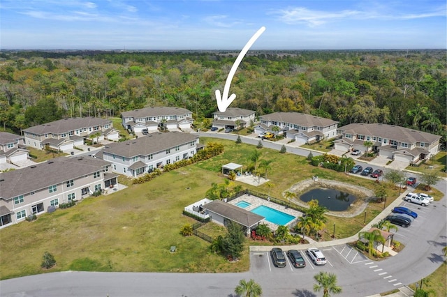 5332 Riverwalk Preserve Dr, New Port Richey, FL 34653 - aerial view of property and surrounding area featuring a forest, a pool, and nearby suburban area