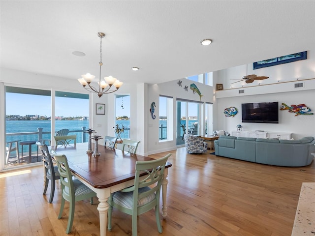 11000 8th St E, Treasure Island, FL 33706 - dining area featuring a chandelier, light wood-style flooring, a ceiling fan, and recessed lighting