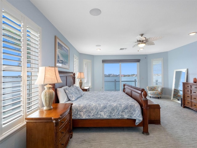 11000 8th St E, Treasure Island, FL 33706 - carpeted bedroom with a water view, recessed lighting, and ceiling fan