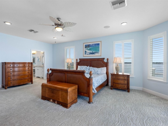 11000 8th St E, Treasure Island, FL 33706 - bedroom with carpet, ceiling fan, and ensuite bathroom