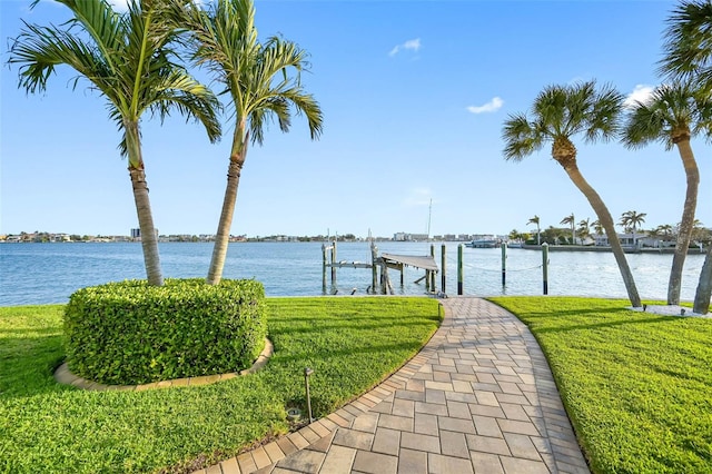 11000 8th St E, Treasure Island, FL 33706 - dock with boat lift, a yard, and a water view