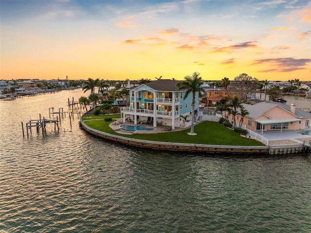 11000 8th St E, Treasure Island, FL 33706 - dock area with a water view, a lawn, a patio, and a balcony