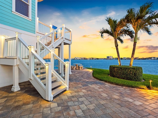 11000 8th St E, Treasure Island, FL 33706 - view of patio / terrace with stairs and a water view