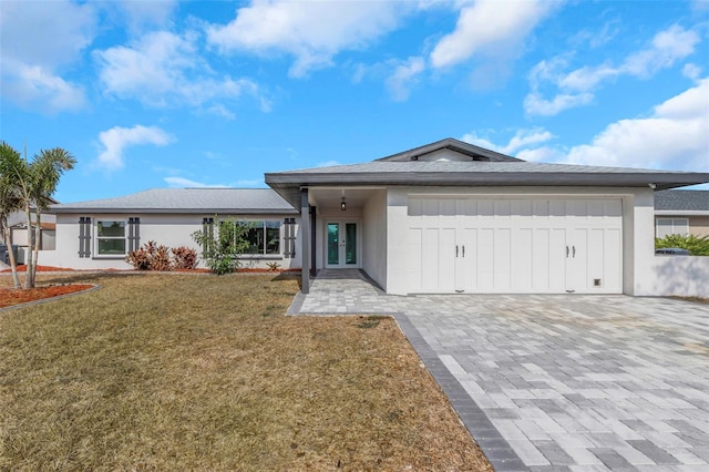 6508 Senegal Palm Way, Apollo Beach, FL 33572 - ranch-style home featuring an attached garage, french doors, decorative driveway, a front yard, and stucco siding