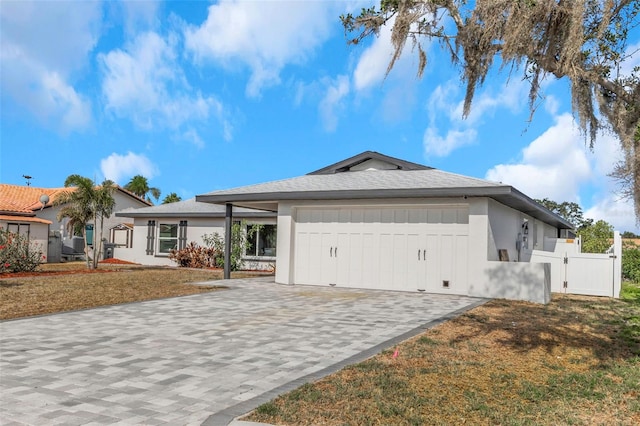6508 Senegal Palm Way, Apollo Beach, FL 33572 - view of front facade featuring an attached garage, decorative driveway, a gate, and stucco siding