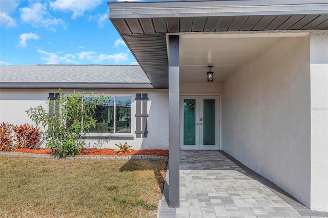 6508 Senegal Palm Way, Apollo Beach, FL 33572 - doorway to property with french doors, stucco siding, and a yard