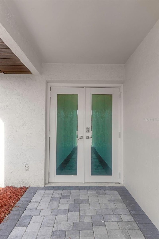 6508 Senegal Palm Way, Apollo Beach, FL 33572 - property entrance with french doors and stucco siding