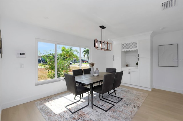 6508 Senegal Palm Way, Apollo Beach, FL 33572 - dining space with a chandelier, baseboards, and light wood-style flooring
