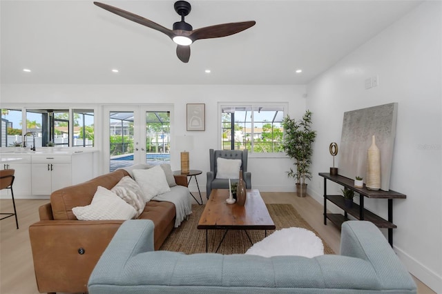6508 Senegal Palm Way, Apollo Beach, FL 33572 - living room with french doors, baseboards, recessed lighting, a ceiling fan, and light wood-style floors