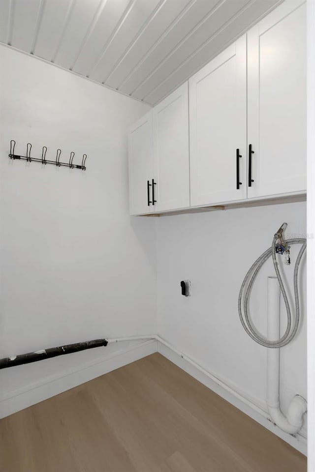 6508 Senegal Palm Way, Apollo Beach, FL 33572 - washroom featuring cabinet space, wood finished floors, hookup for a washing machine, and baseboards