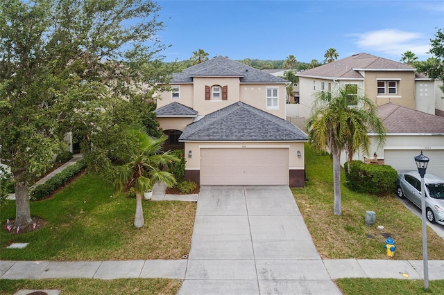 3351 Lintower Dr, Land O Lakes, FL 34638 - view of front of home featuring stucco siding, a front yard, driveway, a shingled roof, and a garage