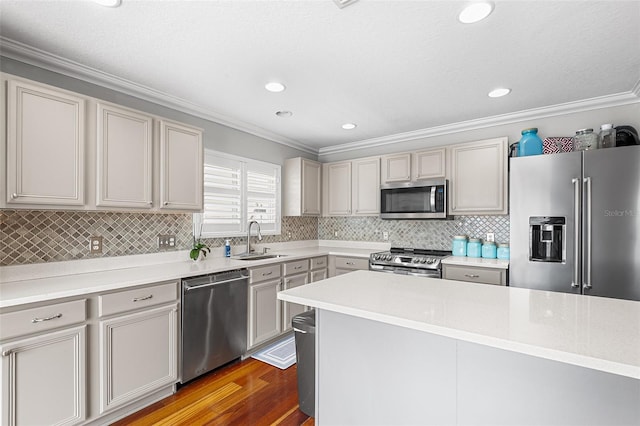 3351 Lintower Dr, Land O Lakes, FL 34638 - kitchen with stainless steel appliances, a sink, crown molding, wood finished floors, and light countertops