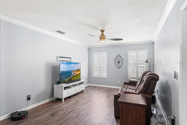 3351 Lintower Dr, Land O Lakes, FL 34638 - living room featuring a ceiling fan, dark wood finished floors, crown molding, baseboards, and a textured ceiling