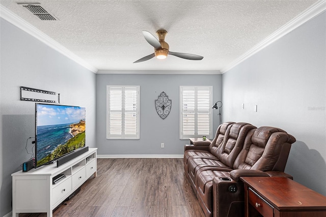 3351 Lintower Dr, Land O Lakes, FL 34638 - living room with dark wood-style flooring, a ceiling fan, crown molding, a textured ceiling, and baseboards