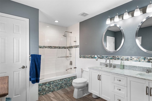 3351 Lintower Dr, Land O Lakes, FL 34638 - full bathroom featuring tiled shower / bath, double vanity, wood finished floors, toilet, and recessed lighting