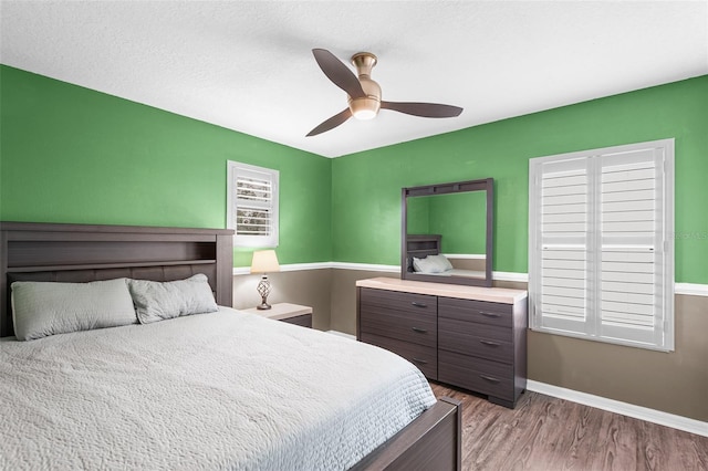 3351 Lintower Dr, Land O Lakes, FL 34638 - bedroom with wood finished floors, a ceiling fan, and baseboards