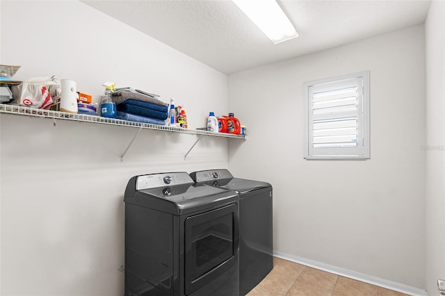3351 Lintower Dr, Land O Lakes, FL 34638 - washroom featuring independent washer and dryer, baseboards, and light tile patterned floors