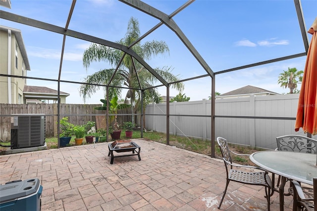 3351 Lintower Dr, Land O Lakes, FL 34638 - fenced backyard featuring central air condition unit, a patio area, a lanai, an outdoor fire pit, and outdoor dining area